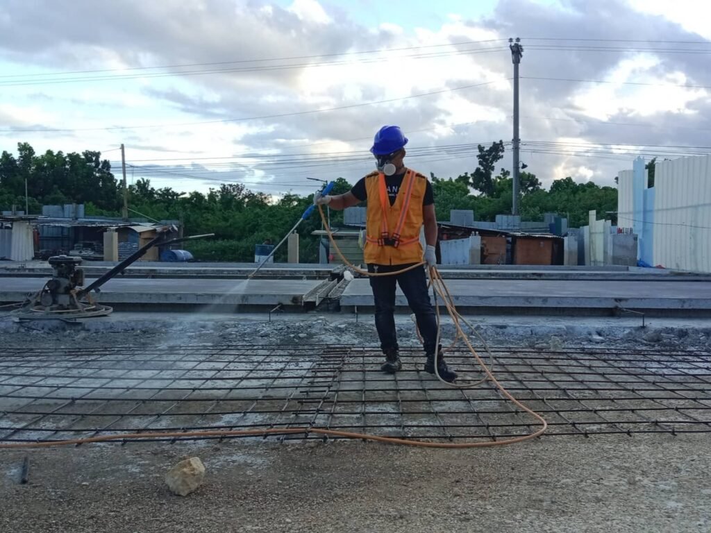 Technologist Pest Control Cebu technician spraying termiticide over steel-reinforced soil during pre-construction soil poisoning treatment.