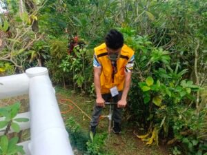 Technologist Pest Control technician performs soil sampling in Boracay garden to assess pest activity and treatment needs